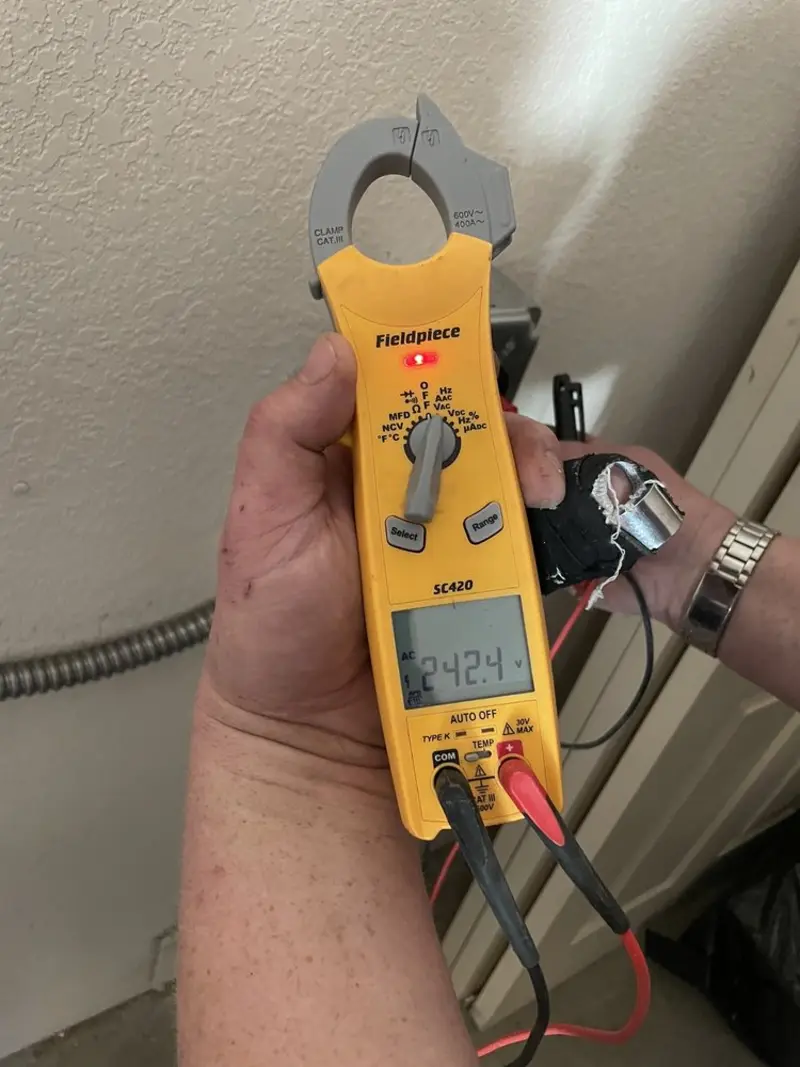 Voltage testing with clamp meter during Electrical Installation Services in Durant